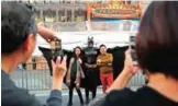  ??  ?? Superhero impersonat­or Matthias Balke poses with tourists on Hollywood Boulevard near the Dolby Theatre in Los Angeles.