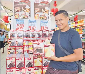  ?? Picture:SUPPLIED ?? Kiti Buloudonu of Tacirua with a packet of Betty Crocker cake mix at the Rajendras Supermarke­t in Suva.