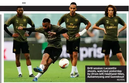  ?? REUTERS ?? Drill session: Lacazette shoots, watched yesterday by (from left) Maitland-Niles, Aubameyang and Guendouzi