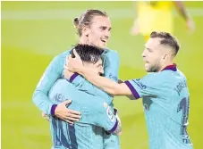  ?? - AFP photo ?? Griezmann (back) celebrates with forward Lionel Messi and defender Jordi Alba (right) after scoring a goal during the Spanish League football match between Villarreal and Barcelona at the Madrigal stadium in Villarreal.