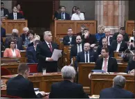  ?? (AP/MTI/Szilard Koszticsak) ?? Hungary’s Prime Minister Viktor Orban (center) speaks in parliament, in Budapest, Hungary on Wednesday.