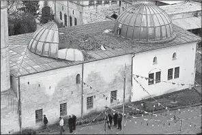  ?? AP/LEFTERIS PITARAKIS ?? This mosque in Kilis, Turkey, near the Syrian border, was damaged by two rockets fired Wednesday from Syria. It was the latest such attack in the town since Turkey began its offensive in Afrin, Syria.