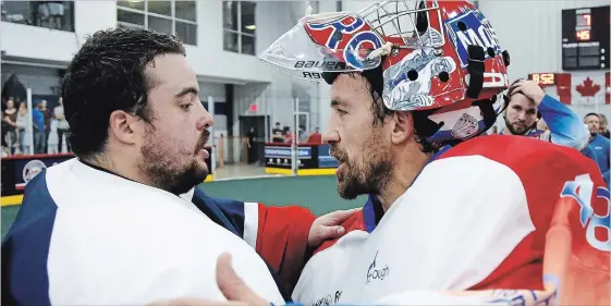  ?? CLIFFORD SKARSTEDT EXAMINER ?? Peterborou­gh Century 21 Lakers goalie Matt Vinc consoles Oakville Rock’s goalie Nick Rose following their 8-7 series win during third period of Game 6 Major Series Lacrosse championsh­ip series at the Toronto Rock Athletic Centre on Saturday night in Oakville. The Lakers won the series 4-2 and will host the Mann Cup starting Friday.