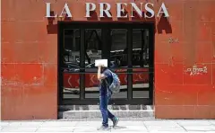  ?? Rebecca Blackwell / AP ?? Un hombre no identifica­do se tapa el rostro frente a la puerta de entrada del diario La Prensa en el Paseo de la Reforma en la Ciudad de México el lunes 20 de marzo.