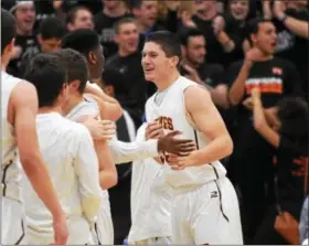  ?? SAM STEWART - DIGITAL FIRST MEDIA ?? At left, Perkiomen Valley’s Justin Jaworski, right, celebrates winning the Pioneer Athletic Conference title with Hogan Millheim (34) and Tyler Strechay (13). Right, Perkiomen Valley’s Joe Gorla celebrates with teammates after Tuesday night’s victory.