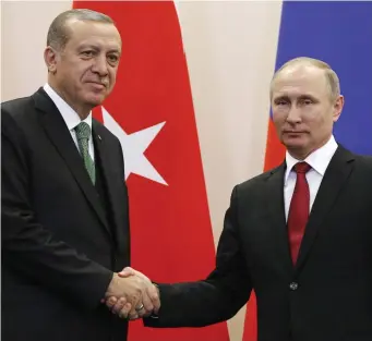  ?? (Reuters) ?? RUSSIAN PRESIDENT Vladimir Putin shakes hands with his Turkish counterpar­t Recep Tayyip Erdogan during a news conference following their talks in Sochi in May.