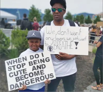  ?? File photo ?? Memorable protest sign of the year: ‘When do I stop being cute and become dangerous?’ read a sign held by Durlin Davis Jr., age 10, at a anti-racism rally held in June at Kelowna’s Stuart Park.