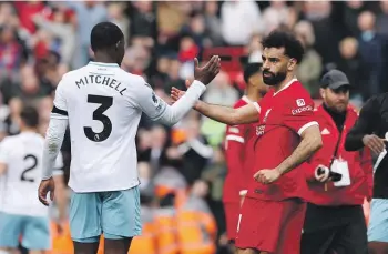  ?? GETTY IMAGES ?? Tyrick Mitchell of Crystal Palace and Mohamed Salah of Liverpool shake hands after the Premier League match at Anfield yesterday.