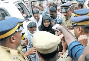  ??  ?? Akhila Asokan, who converted to Islam in 2016 and took a new name, Hadiya, arrives at an airport in Kochi, India, on November 25, 2017.