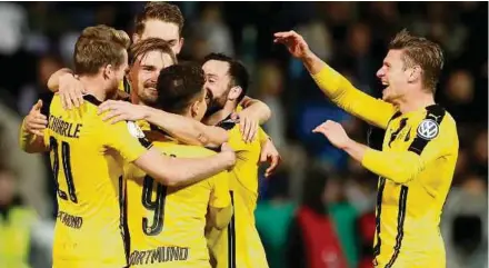  ?? EPA PIC ?? Dortmund's Marcel Schmelzer (second from left) celebrates with teammates after scoring the third goal against Sportfreun­de Lotte in the German Cup quarter-final on Tuesday.