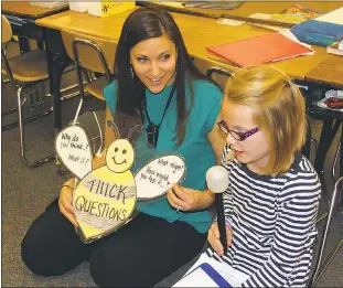  ?? SUBMITTED PHOTO ?? Jillian Durr, a nine-year teaching veteran at Dr. James Craik Elementary School, helps Emmalyn Fetters come up with ideas for a writing assignment. Students pretended to be broadcaste­rs reading from a news report about the Chesapeake Bay. Durr, a...