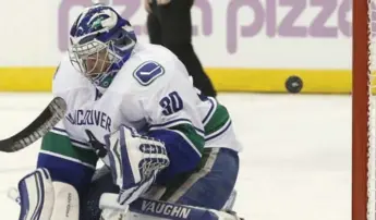  ?? RICK MADONIK/TORONTO STAR ?? Canucks goalie Ryan Miller fails to stop a deflection off the stick of Leafs rookie Mitch Marner at the ACC.