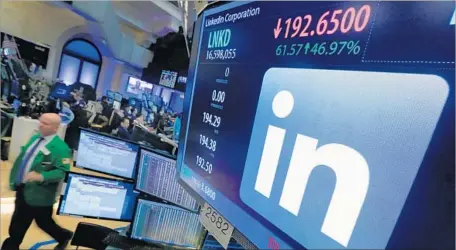  ?? Richard Drew Associated Press ?? LINKEDIN SHARES soared after word of the company’s acquisitio­n by Microsoft, as seen at the New York Stock Exchange on Monday.