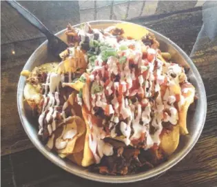  ?? STAFF PHOTOS BY CHRIS ZELK ?? Edley’s Bar-B-Que’s BBQ Nachos with beef brisket.