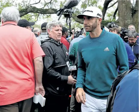  ?? ROB CARR/GETTY IMAGES ?? Dustin Johnson walks off after announcing his withdrawl from the 2017 Masters last week at Augusta National Golf Club in Augusta, Ga.