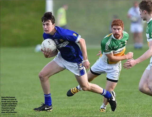  ?? Pictures: Colin Bell ?? Daire McConnon (St Mary’s) tries to break away from St Joseph’s duo Daire Smyth and Killian Staunton during Saturday’s SFC play-off in Dunleer.