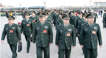  ??  ?? Military delegates arrive at the Tiananmen Square for the opening session of the National People’s Congress. — Reuters photo