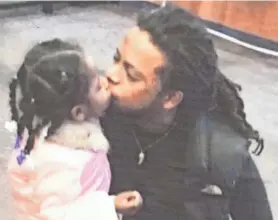  ?? MIKE DE SISTI / MILWAUKEE JOURNAL SENTINEL ?? A photo of Isaiah Allen with his daughter hangs on the wall of a tent set up outside the Teutonia Gas & Food gas station, 4295 N. Teutonia Ave., in September.