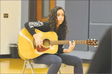  ?? Alex von Kleydorff / Hearst Connecticu­t Media ?? Vanessa Mercedas, of Stratford, plays a song she wrote about family tradition during the Christmas holidays as she rehearses with others at the Regional Center for the Arts in Trumbull on Oct. 2.