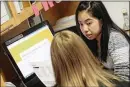  ?? GETTY IMAGES ?? Kelley Mui helps a client sign up for an insurance program last week at the Midwest Asian Health Associatio­n in Chicago.