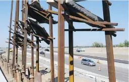  ?? THE CANADIAN PRESS ?? Traffic passes Bowfort Towers by New York artist Del Geist, near Canada Olympic Park in Calgary.