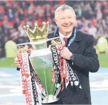  ?? — AFP photo ?? Ferguson holds the Premier League trophy in this May 12, 2013 file photo.