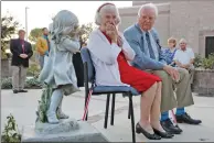  ?? Katharine Lotze/The Signal ?? Jacqulyn Petersen is overcome with emotion as she sits beside husband Harold Petersen as a newly-dedicated children’s garden bearing their name is unveiled at the Child and Family Center on Tuesday.