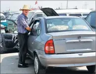  ?? LI MING / FOR CHINA DAILY ?? A dealer waits to sell a used car at a trade center in Zaozhuang, Shandong province.