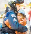  ?? Picture / AP ?? The image of Devonte Hart hugging a police officer in 2014 was seen around the world.