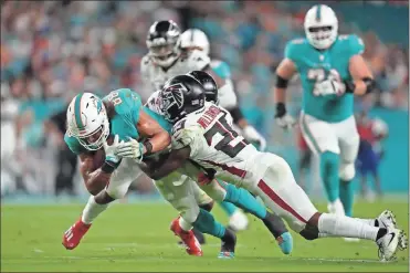  ?? Jasen Vinlove/ uSa Today Sports ?? Atlanta Falcons cornerback Chris Williamson tackles Miami Dolphins wide receiver Mack Hollins during the first half at Hard Rock Stadium.