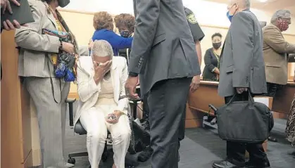  ?? PHELAN M EBENHACK/ORLANDO SENTINEL ?? Carol Greenlee Crawley, second from left, daughter of Charles Greenlee, reacts after Circuit Court Judge Heidi Davis dismissed all charges against Ernest Thomas, Samuel Shepherd, Charles Greenlee and Walter Irvin, known as the Groveland Four, during a proceeding at the Lake County Courthouse on Monday in Tavares. The four were falsely accused of raping 17-year-old Norma Padgett and assaulting her husband in 1949.