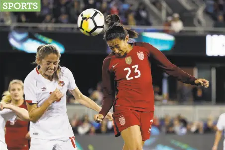  ?? Photos by Eric Risberg / Associated Press ?? U.S. forward Christen Press (23) heads the ball in front of Canada’s Janine Beckie in the Americans’ 3-1 win at Avaya Stadium.