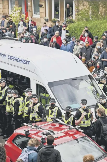  ??  ?? 2 Protesters block a UK Home Office van to prevent it leaving Kenmure Street in Glasgow