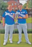  ??  ?? Gavin and Lee with the British Isles Bowls Council junior championsh­ip trophy.