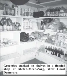  ?? ?? Groceries stacked on shelves in a flooded shop at Meten-Meer-Zorg, West Coast Demerara