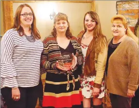  ?? Westside Eagle Observer/RANDY MOLL ?? Dr. Desirae Self, with staff members Krystal Reeves, Katherine Chamberlai­n and Sondra Baker, holds the Business of the Year Award presented to the Gentry Veterinary Clinic for 25 years of service to the community.