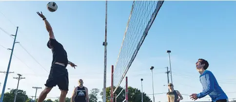  ??  ?? At dusk, volleyball players get in a last game at the famed sand courts at O’Leaver’s Pub.