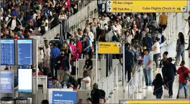  ?? AP PHOTO/JULIA NIKHINSON ?? People wait in a TSA line at the John F. Kennedy Internatio­nal Airport on Tuesday in New York.