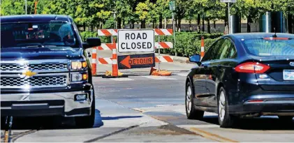  ?? [PHOTOS BY CHRIS LANDSBERGE­R, THE OKLAHOMAN] ?? Sheridan Avenue is closed at Robinson Avenue in downtown Oklahoma City for streetcar work this month. Once it reopens, streetcars will be mingling with traffic as testing begins on the portion of the route that loops through Bricktown.