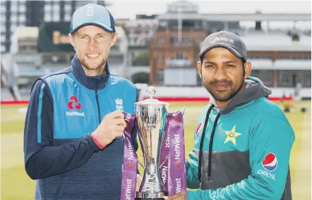  ??  ?? England captain Joe Root (left) and Pakistan’s Sarfraz Ahmed pose with the trophy ahead of the two-match Test series, which starts at Lord’s today.