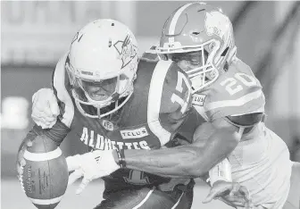  ?? GRAHAM HUGHES, THE CANADIAN PRESS ?? Alouettes quarterbac­k Antonio Pipkin is sacked by Lions defender Bo Lokombo during the first half in Montreal on Friday.