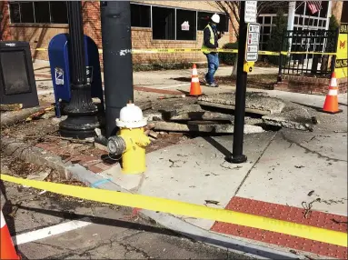  ?? EVAN BRANDT — MEDIANEWS GROUP ?? A PECO worker warily inspects the site of an undergroun­d electrical at High and Hanover streets Friday morning.