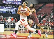  ?? Special to the Democrat-Gazette/AMMAR TAQI ?? Arkansas State’s Tristin Walley drives to the basket as UALR’s Kris Bankston defends Saturday at First National Bank Arena in Jonesboro. Walley had 13 points and 10 rebounds to help the Red Wolves win 72-65.