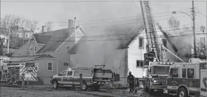  ?? GREG MCNEIL/CAPE BRETON POST ?? An early morning fire destroyed a vacant duplex on Forrest Street in North Sydney on Tuesday. Firefighte­rs from the North Sydney and Sydney Mines volunteer fire department­s are shown at the scene.