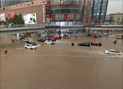  ?? Photo: Nampa/AFP ?? Drenched… Vehicles are stranded after heavy downpours in the Chinese city of Zhengzhou, Henan province.