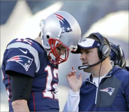  ?? ASSOCIATED PRESS FILE PHOTO ?? In this file photo, New England Patriots quarterbac­k Tom Brady talk to Josh McDaniels.