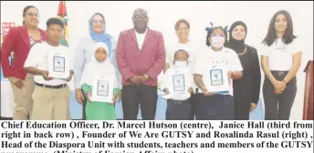  ?? ?? Chief Education Officer, Dr. Marcel Hutson (centre), Janice Hall (third from right in back row) , Founder of We Are GUTSY and Rosalinda Rasul (right) , Head of the Diaspora Unit with students, teachers and members of the GUTSY programme. (Ministry of Foreign Affairs photo)