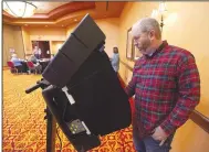  ?? (NWA Democrat-Gazette/J.T. Wampler) ?? Chris Dillon of Bentonvill­e votes Tuesday at the Rogers Convention Center.