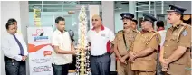  ??  ?? People’s Merchant Finance PLC CEO Nishantha Gunasekara lighting the oil lamp at Suwasahana Medical Clinic, PMF head office