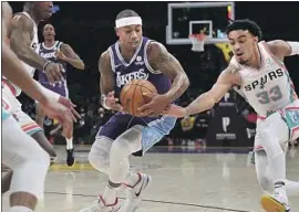  ?? Luis Sinco Los Angeles Times ?? ISAIAH THOMAS tries to protect the ball from the Spurs’ Tre Jones. The Lakers were without several players, and Frank Vogel, for the Staples Center finale.